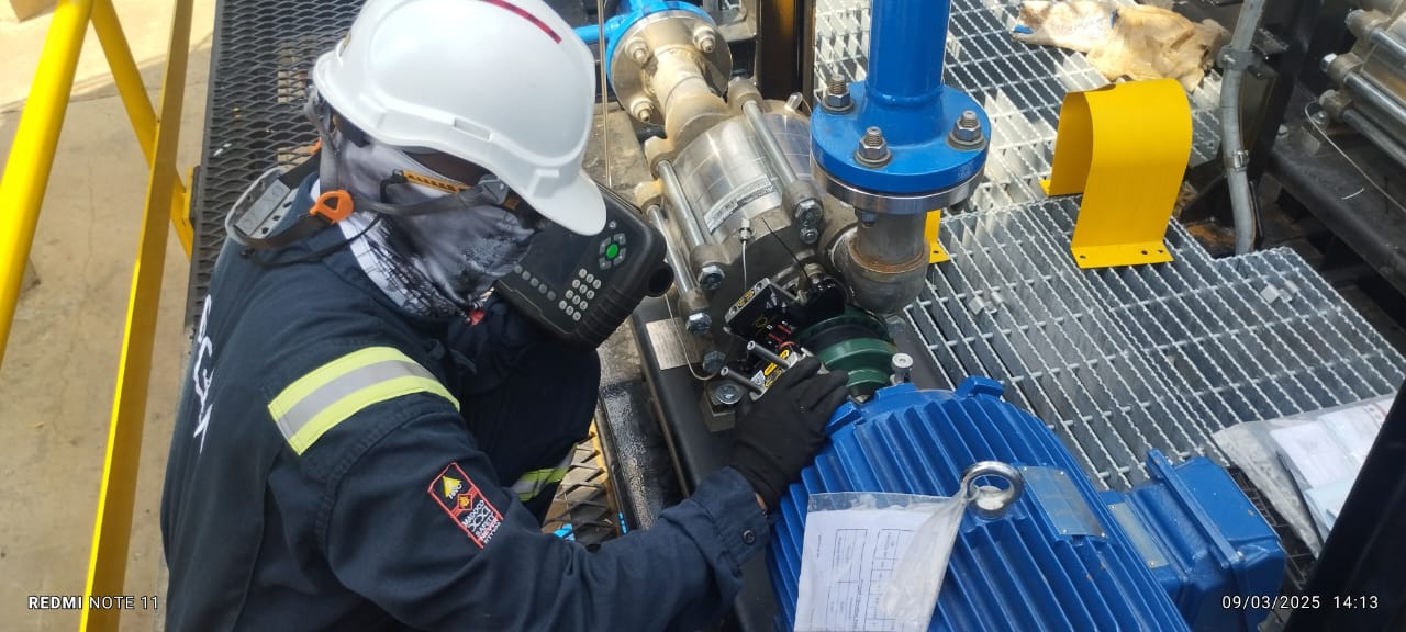 Técnico usando equipo de alineación láser en maquinaria rotativa